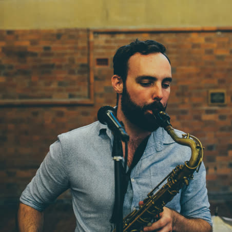 Jake, HOT DAMN! bandleader, playing tenor saxophone at a live gig